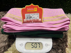Pink fabric with a label on top of a digital scale