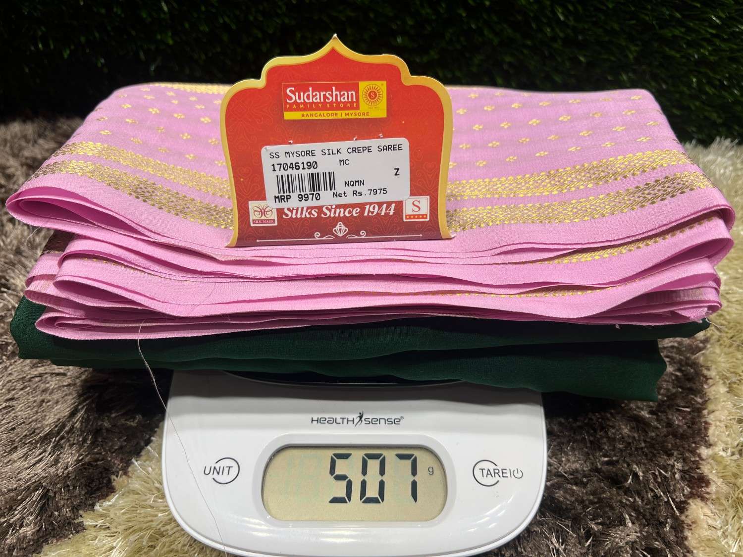 Pink fabric with a label on top of a digital scale