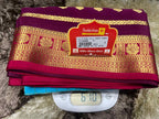 Stack of colorful sarees with a Sudarshan label on a digital scale
