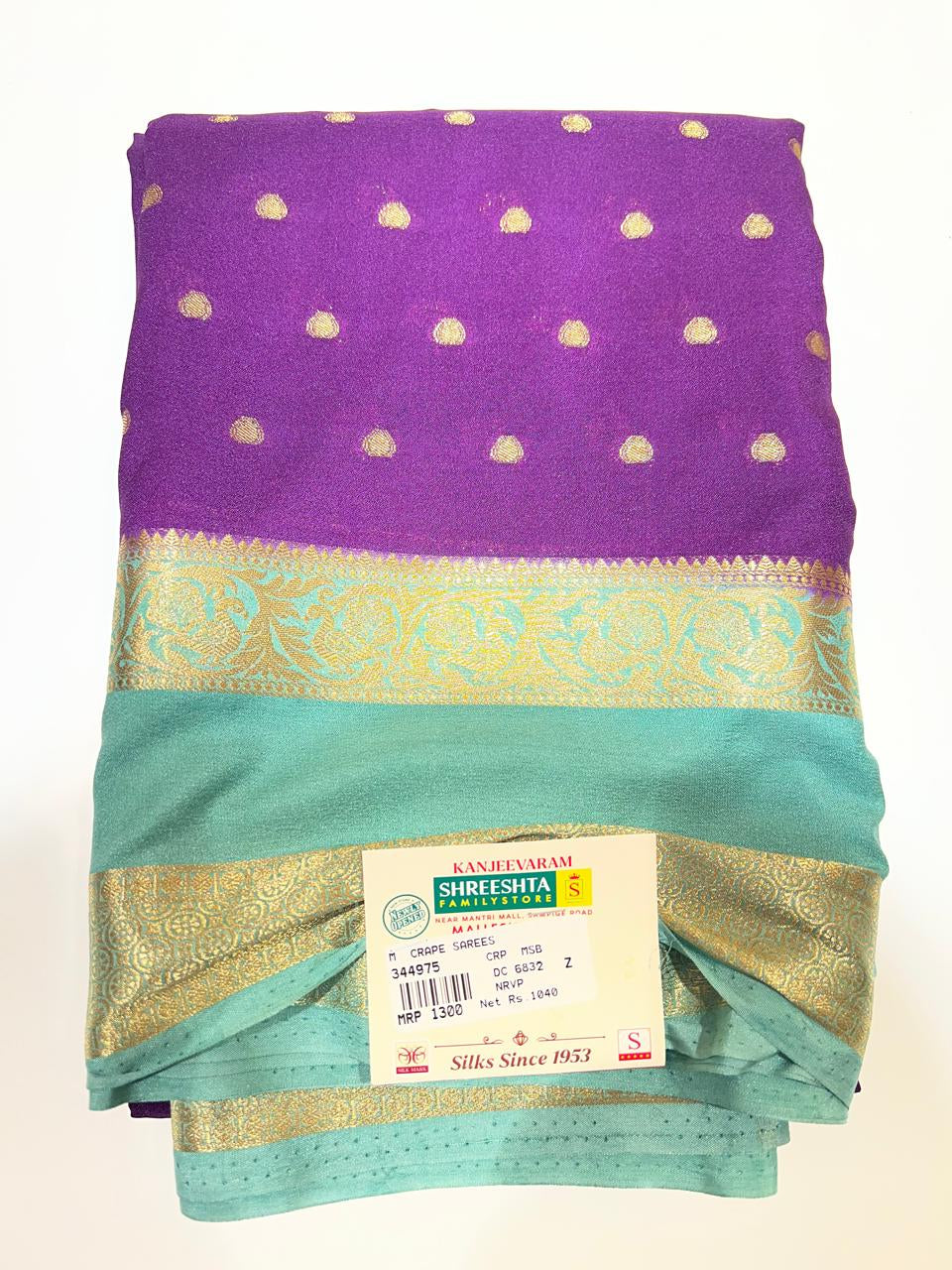 Saree with a purple and green pattern on a white background