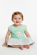 Baby girl wearing mint green cat dress