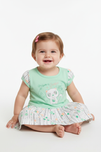 Baby girl wearing mint green cat dress