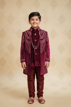 Boy wearing magenta velvet sherwani