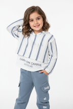 Girl wearing striped knit sweater and cargo pants