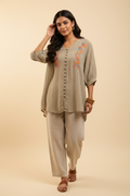 Indian model wearing beige floral embroidery crinkle tunic