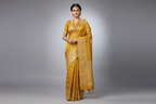 Indian Model Wearing Mustard Yellow Tissue Silk Saree with Silver Buttas