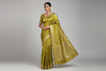 Indian Model Wearing Olive Green Tissue Silk Saree with Gold Zari