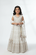 Kid wearing white lehenga