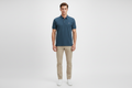 Male model wearing dark teal polo