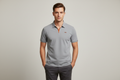 Male model wearing light grey polo shirt
