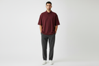 Male model wearing maroon oversized polo