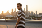 Male model wearing olive striped polo - over shoulder pose