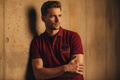 Male model wearing red polo - wall lean pose