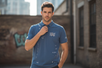 Male model wearing steel blue Stolen Moon polo
