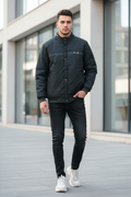 Man Wearing Black Padded Bomber Jacket