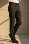 Model in aesthetic pose wearing black formal trousers, lower body