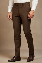 Model in aesthetic pose wearing dark brown formal trousers, lower body