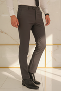 Model in aesthetic pose wearing dark charcoal formal trousers, lower body
