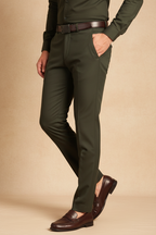 Model in aesthetic pose wearing dark olive green formal trousers, lower body