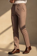 Model in aesthetic pose wearing mauve taupe formal trousers, lower body