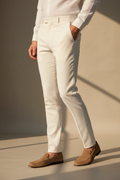 Model in aesthetic pose wearing off-white formal trousers, lower body