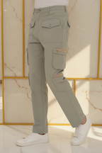 Model in aesthetic pose wearing sage green cargo pants, lower body