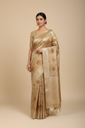 Model wearing champagne gold Banarasi tissue saree