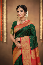 Model wearing dark green Kanchipuram silk saree with bright red gold zari border