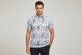 Model wearing geometric print polo shirt - front