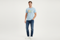Model wearing light blue Levi's graphic t-shirt