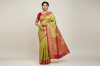 Model wearing Lime Green Kanjivaram Silk Saree with Red Border