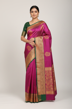 Model wearing magenta fuchsia Banarasi saree with gold green border