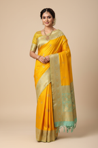 Model wearing mango yellow Banarasi saree with mint green border