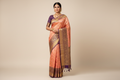 Model wearing Peach Pink Kanjivaram Silk Saree