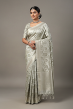 Model wearing pure silver white zari brocade tissue saree