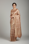 Model wearing rose-gold Banarasi tissue saree