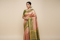 Model wearing Rose Gold Kanjivaram Silk Saree