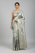 Model wearing sage green abstract print Banarasi saree
