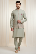 Model wearing sage green embroidered kurta with Nehru jacket