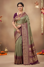 Model wearing sage green Kanchipuram silk saree with wine purple peacock elephant border