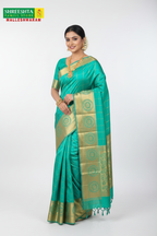 Model wearing Shreeshta turquoise saree with gold zari check and floral border