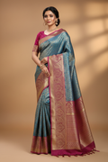 Model wearing teal and magenta Kanjivaram saree