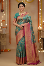 Model wearing teal Banarasi saree with magenta border