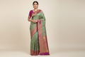 Model wearing Teal Banarasi Silk Saree with Magenta Border