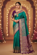 Model wearing teal Kanchipuram silk saree with deep purple peacock border