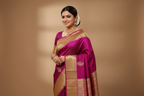 Woman wearing deep magenta fuchsia saree with antique gold geometric zari border