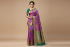 Woman wearing lavender purple saree with teal green heavy gold zari border