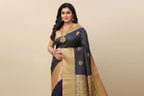 Woman wearing navy black pinstripe saree with gold swan motifs and heavy gold zari pallu