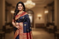 Woman wearing navy blue saree with red gold elephant motif border